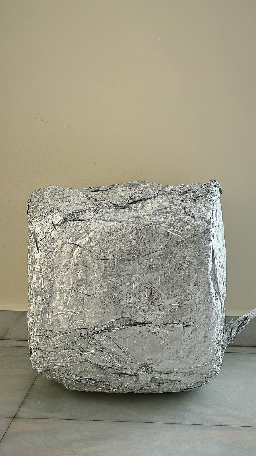 Large aluminium foil cuboid on the floor