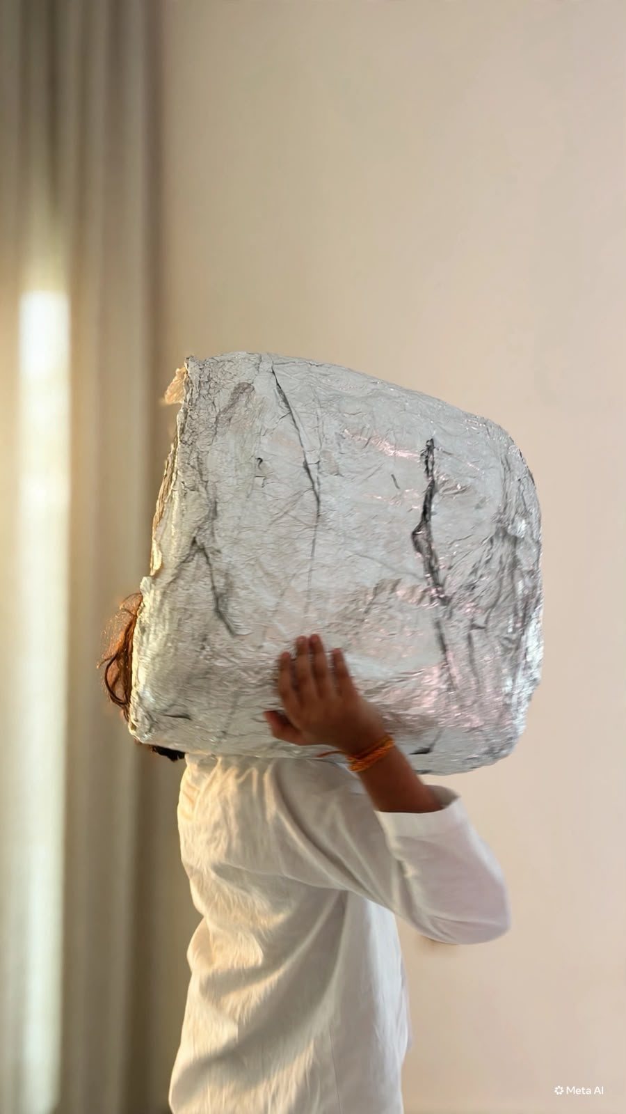 Ridhaan holding up the aluminium foil cuboid