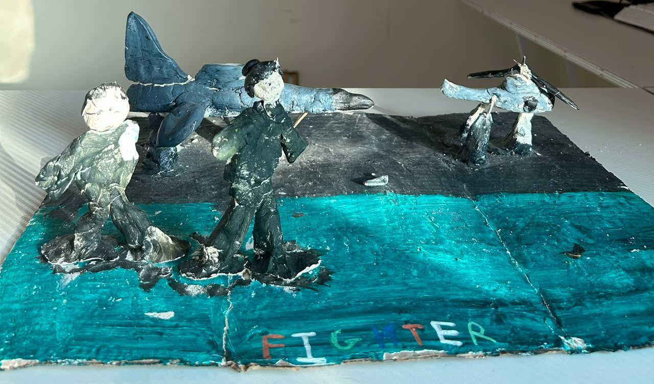 Painted model scene with the word Fighter