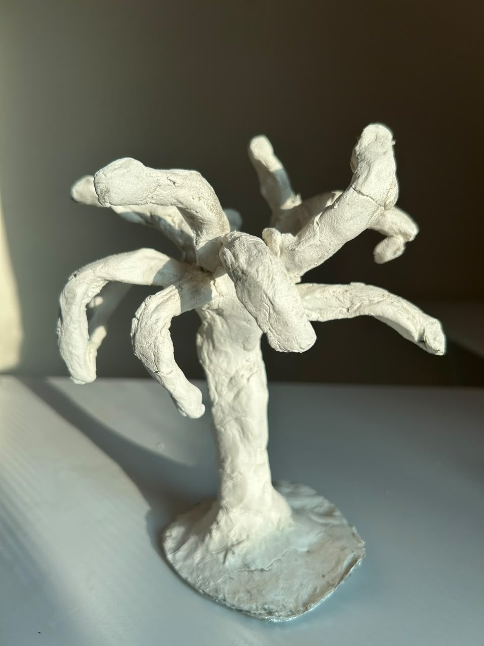 White sculpture with branching arms