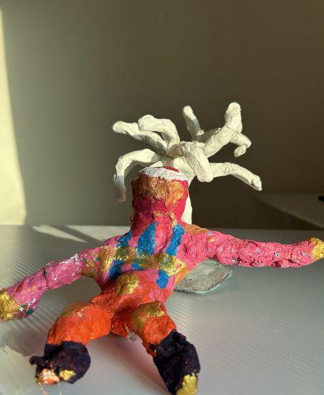 Brightly painted sculpture of a figure